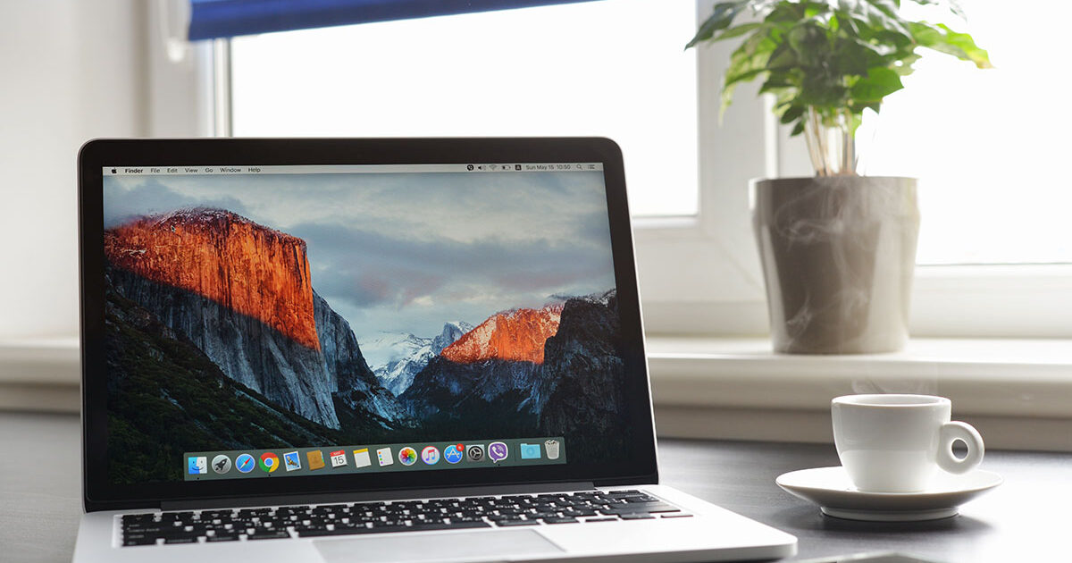 Mac computer with hard drive and diagnostic tools showing APFS file system compatibility issues