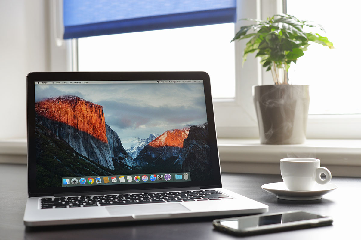Mac computer with hard drive and diagnostic tools showing APFS file system compatibility issues
